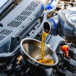 About auto mechanic pouring engine oil 600nw 2462473495