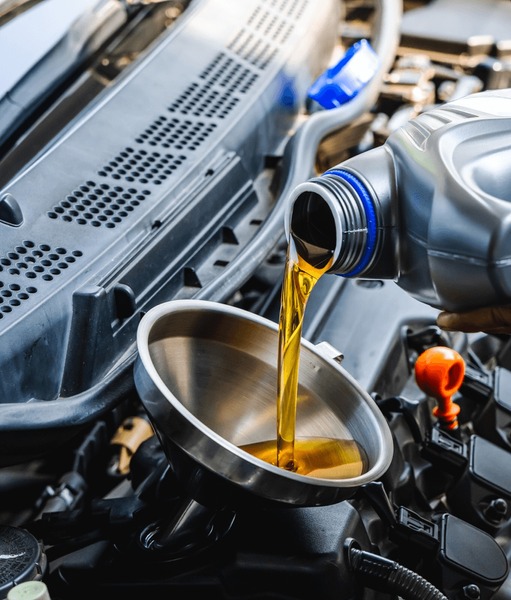 Home auto mechanic pouring engine oil 600nw 2462473495